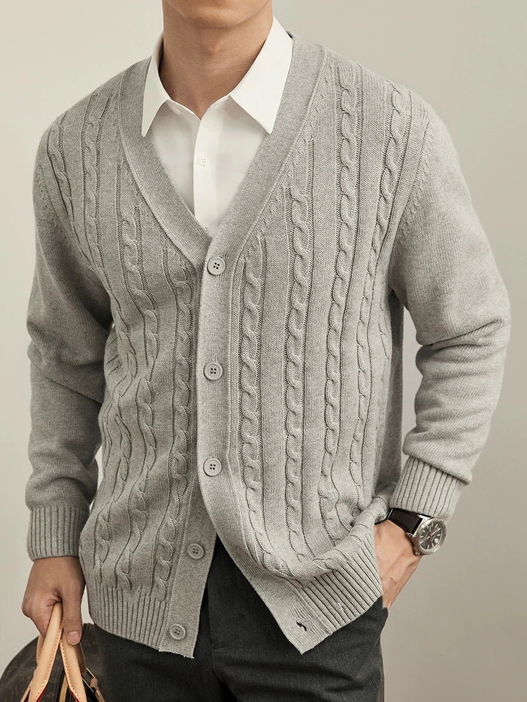 Man wearing a navy cable-knit cardigan over a white shirt