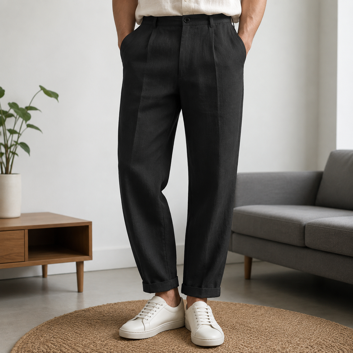 Man wearing black relaxed cropped trousers with white sneakers