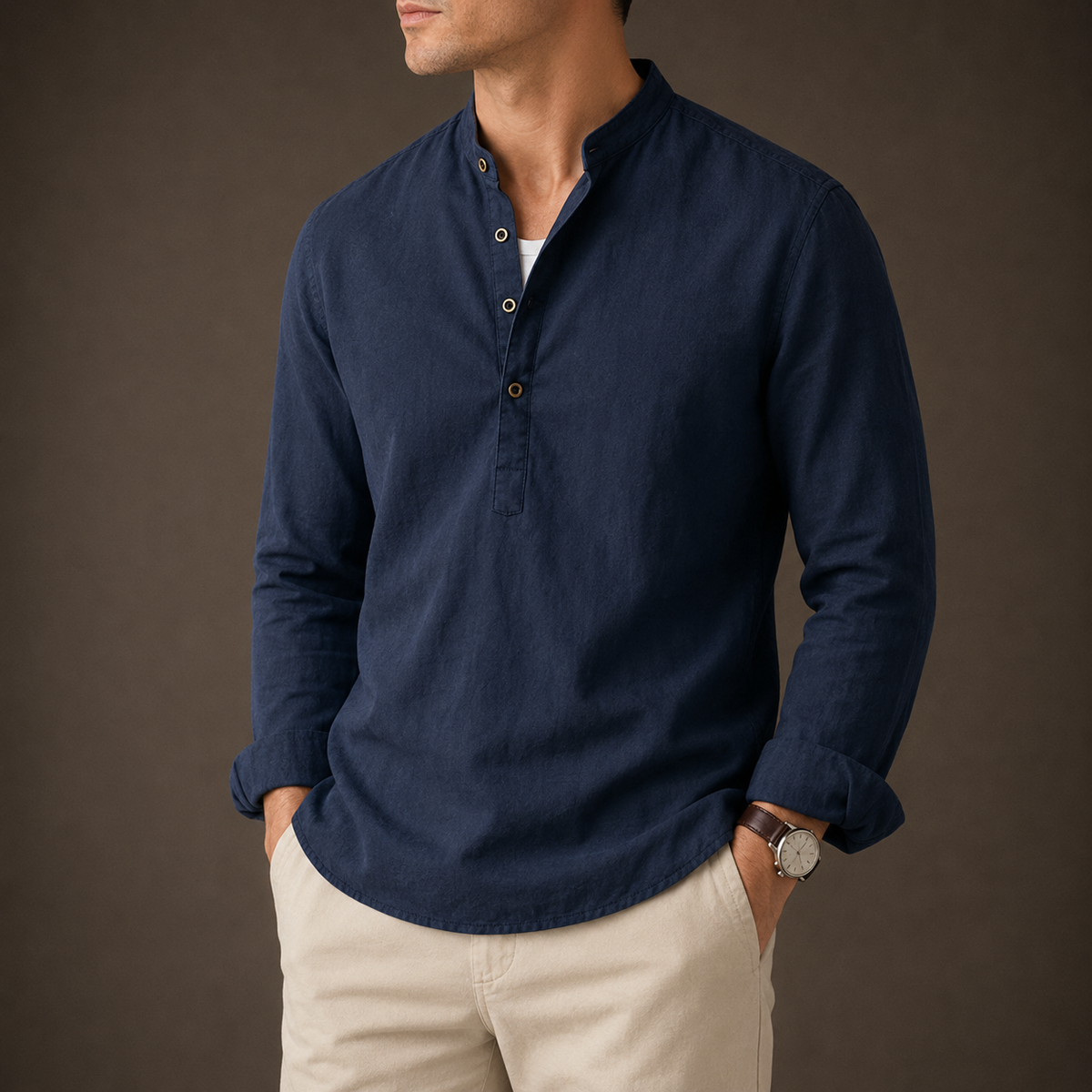 Man wearing a navy Mandarin-collar linen shirt with beige trousers