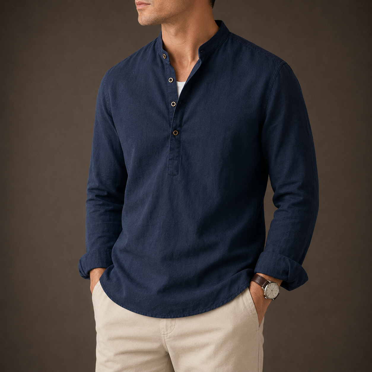 Man wearing a navy Mandarin-collar linen shirt with beige trousers