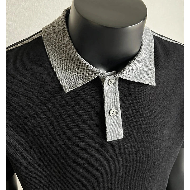 Close-up of a black knit polo with gray contrast collar and placket