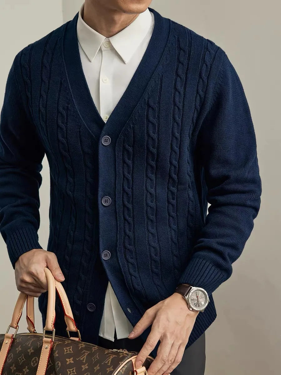 Front view of a navy cable-knit V-neck cardigan on a man