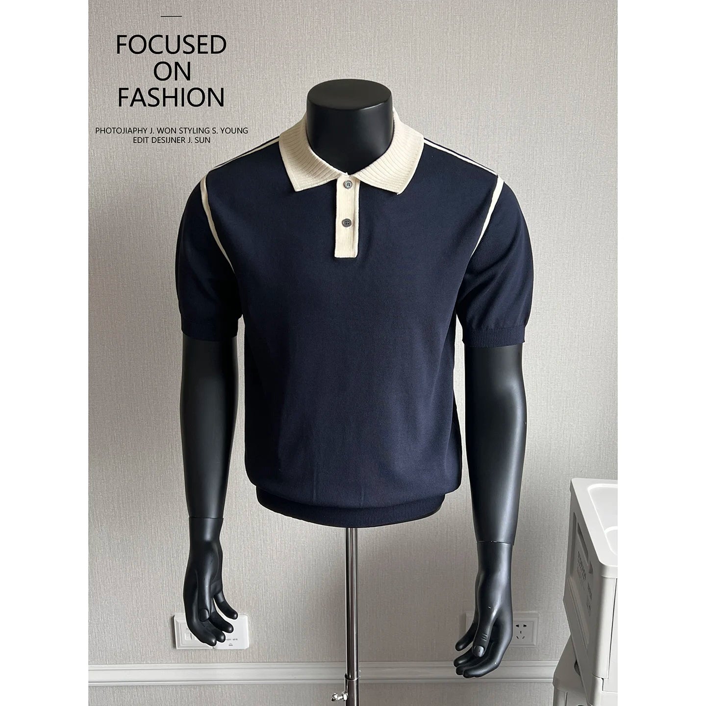 Navy knit polo with cream contrast collar on a mannequin