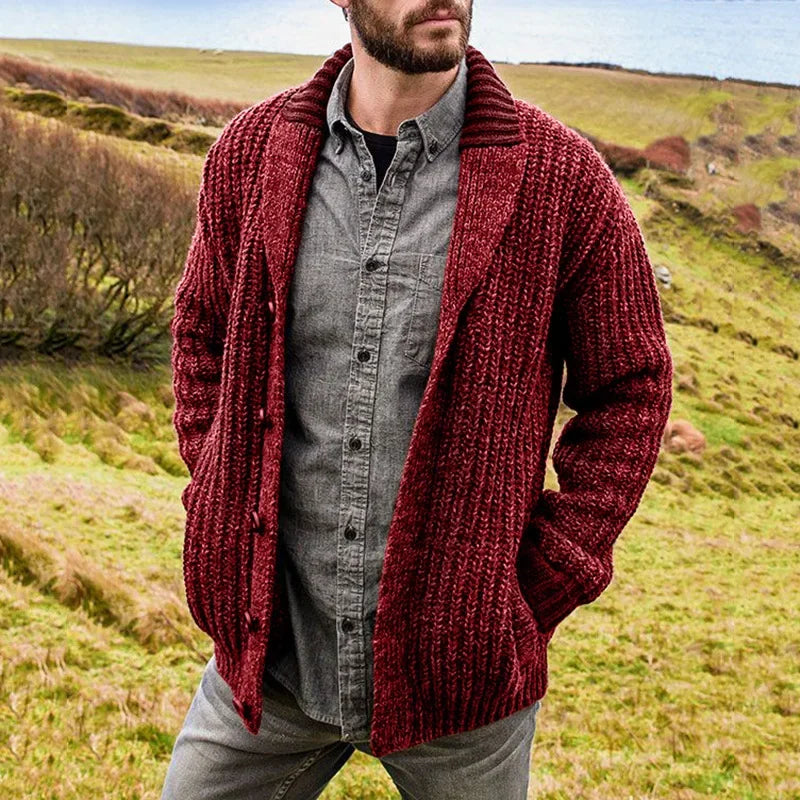 Man wearing a red shawl-collar cable-knit cardigan outdoors
