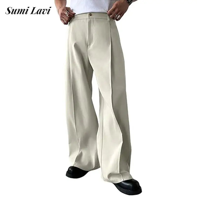 Cream pleated straight-leg trousers on a plain background