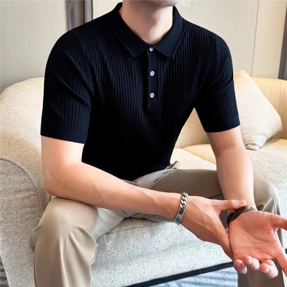 Seated man wearing a black slim-fit knit polo