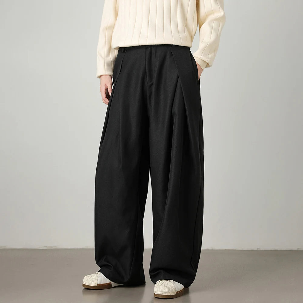 Man wearing black relaxed wide-leg trousers