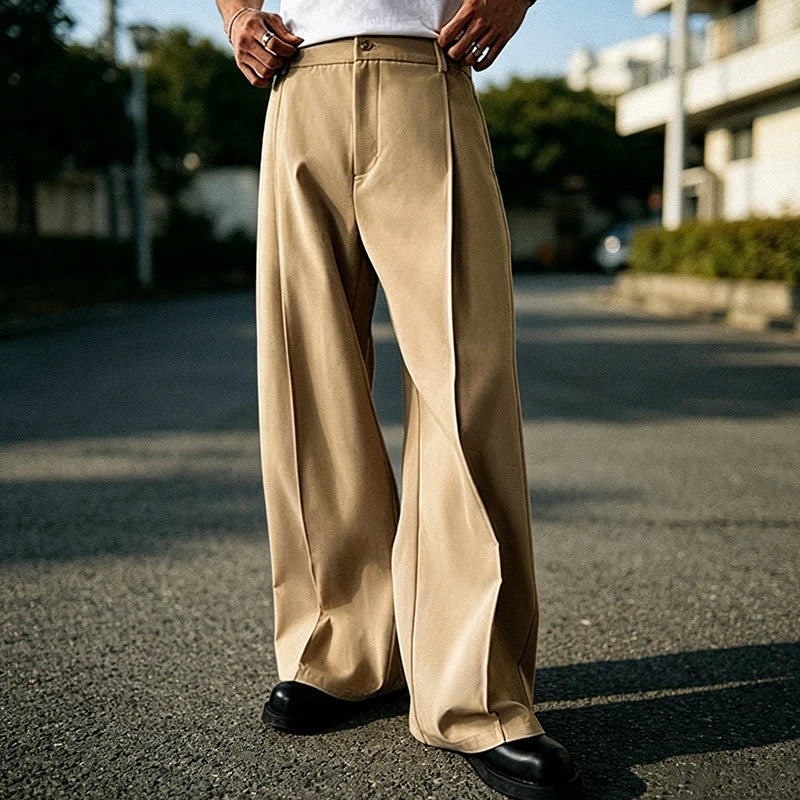 Front view of khaki pleated straight-leg trousers on a man
