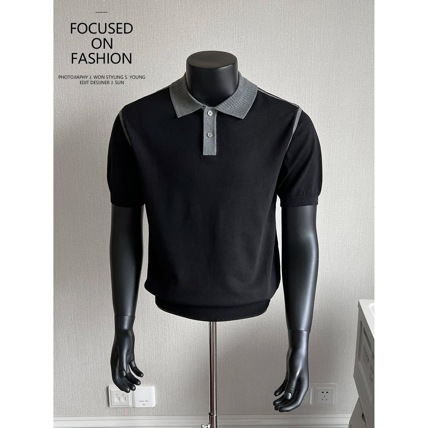 Black knit polo with gray contrast trim on a mannequin