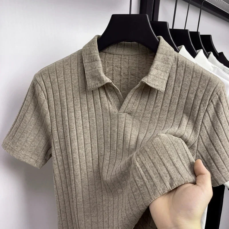 Close-up of a khaki ribbed knit polo on a hanger