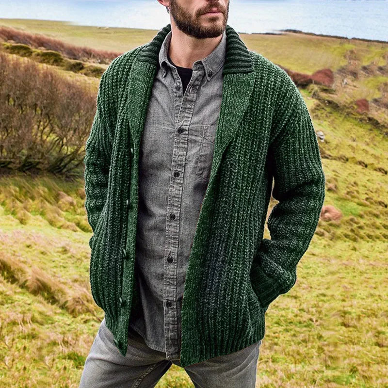 Man wearing a green shawl-collar cable-knit cardigan outdoors