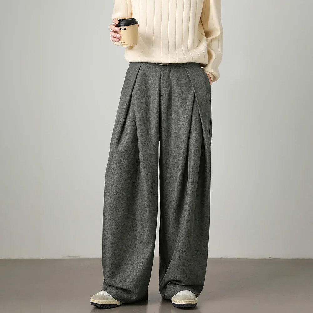 Man wearing gray relaxed wide-leg trousers