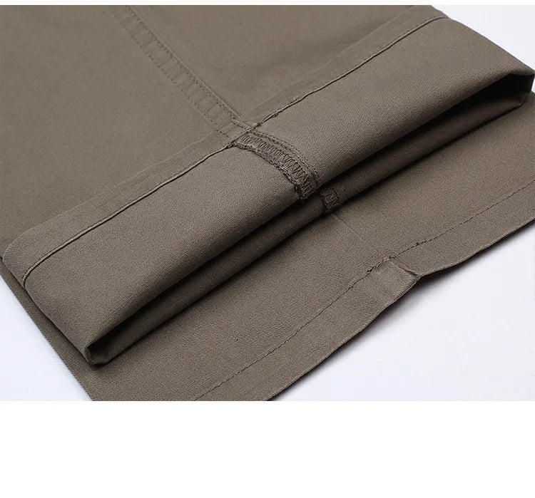 Folded trouser fabric showing hem stitching and texture