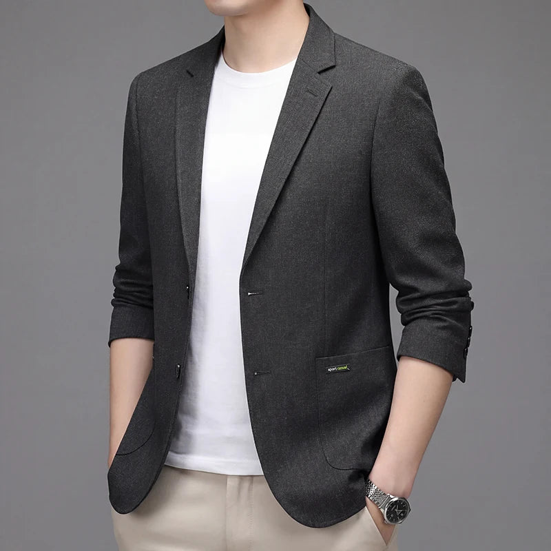 Man wearing a black lightweight blazer over a white T-shirt