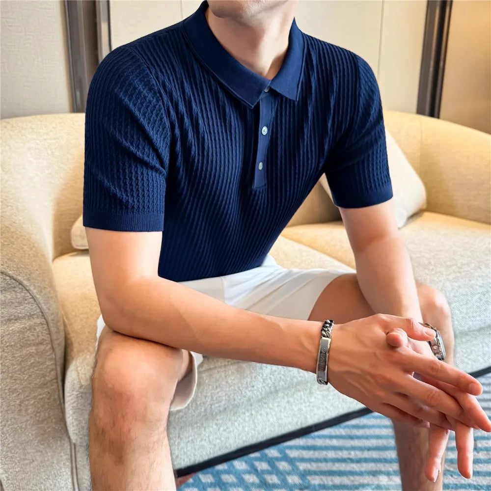 Seated man wearing a blue slim-fit knit polo