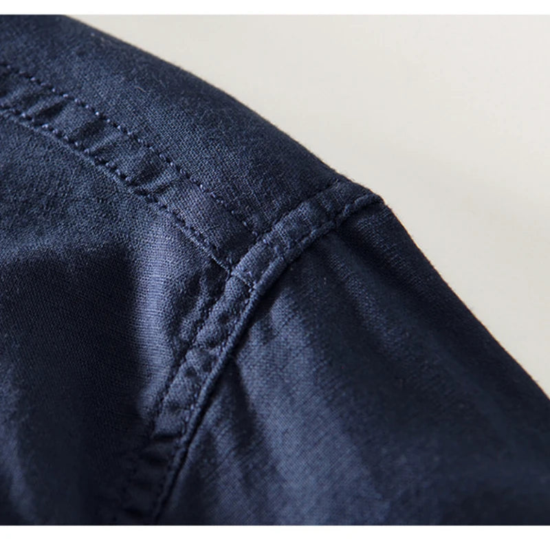 Close-up of the navy shirt shoulder seam and woven texture