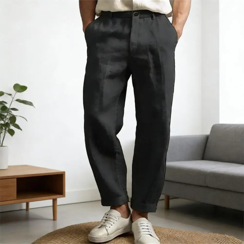 Angled view of black cropped trousers with tapered legs