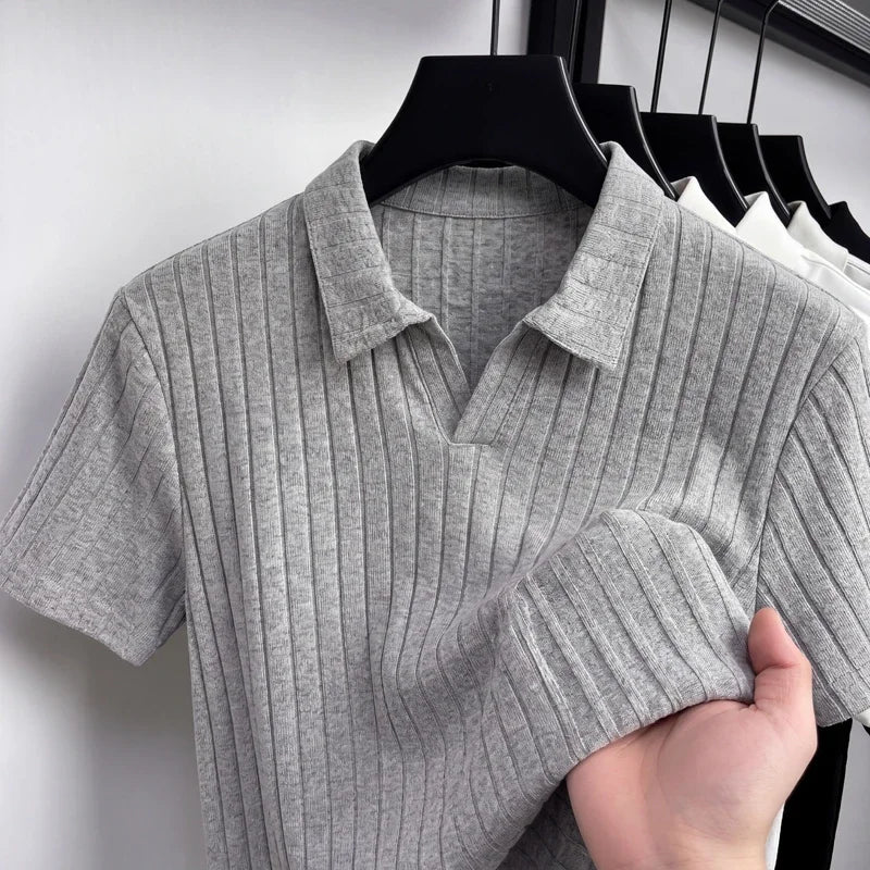 Close-up of a light-gray ribbed knit polo on a hanger