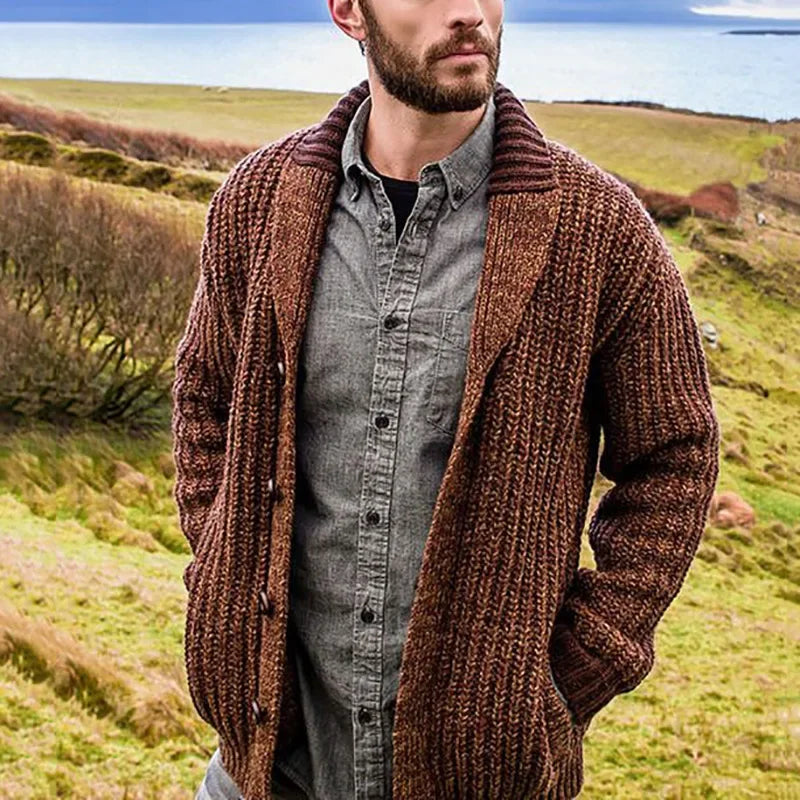 Man wearing a brown shawl-collar cable-knit cardigan outdoors