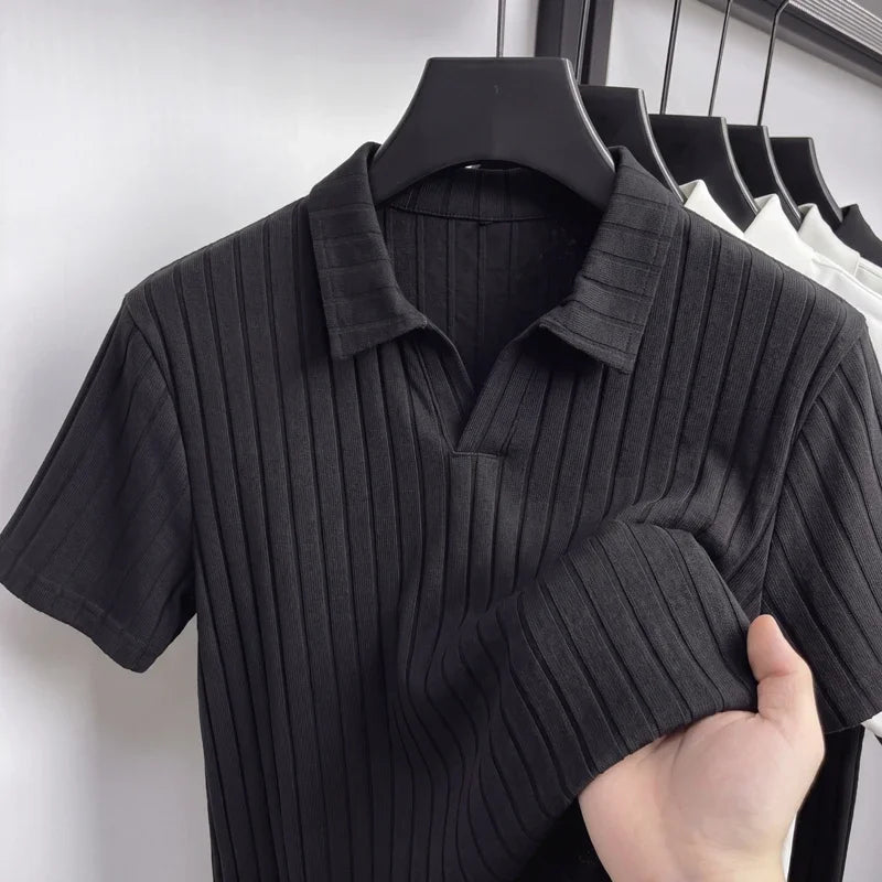 Close-up of a black ribbed knit polo on a hanger