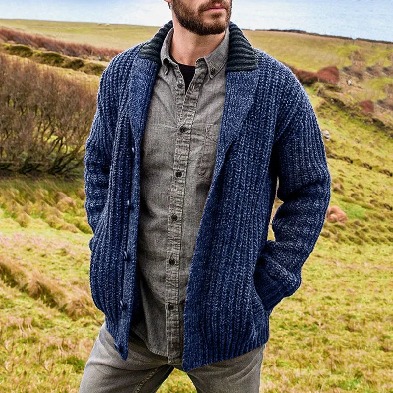 Man wearing a blue shawl-collar cable-knit cardigan outdoors